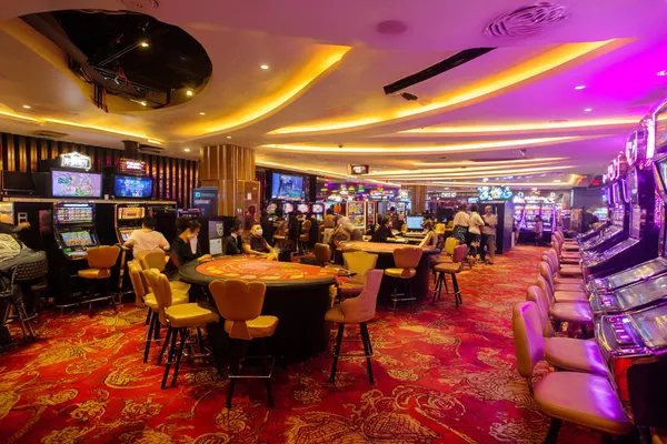 HHBDBAJE App — Enjoy seamless gaming on your smartphone A young woman relaxing with her phone while dynamic casino elements float around her, illustrating the smooth mobile experience offered by the HHBDBAJE app.